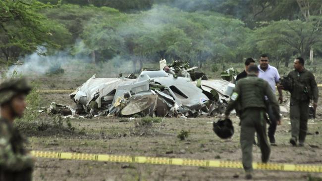 Colombian soldiers walk next to the wreckage of the CASA 235 air force plane that crashed in Las Palomas in Cesar province some 800 km northeast of Bogota