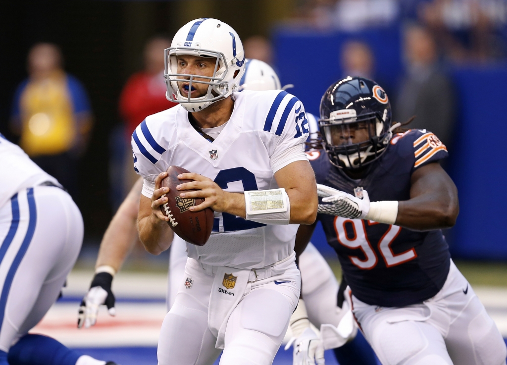 Indianapolis Colts quarterback Andrew Luck is chased by Chicago Bears defensive end Pernell Mc Phee during the first half of an NFL preseason football game in Indianapolis Saturday Aug. 22 2015