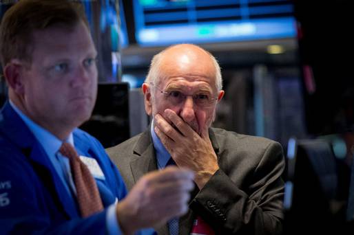 Concern on the faces of New York Stock Exchange traders as Wall Street falls for the fourth consecutive day