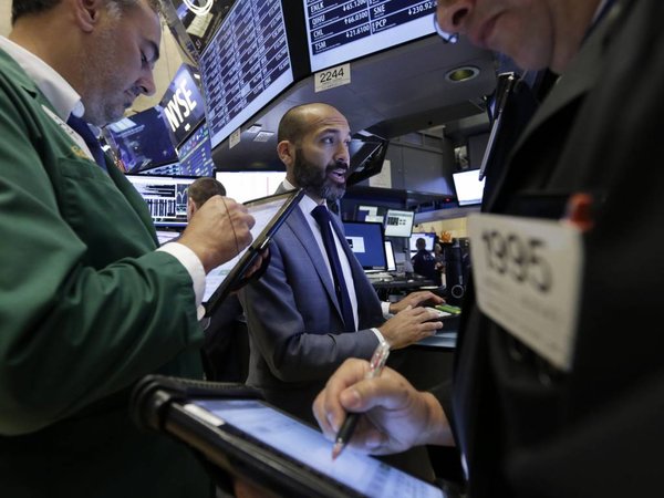 Specialist Fabian Caceres center works on the floor of the New York Stock Exchange on Tuesday Aug. 11 2015