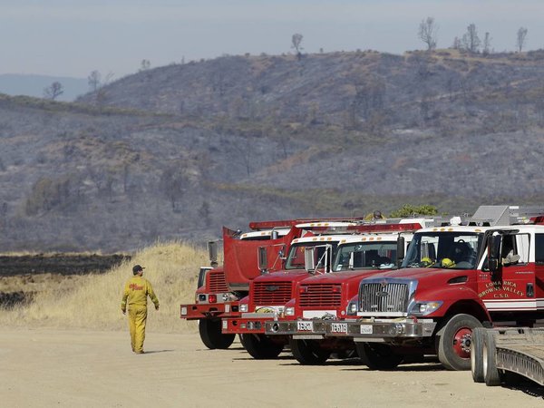 Fire trucks are shown parked at a staging area near a fire in Napa County Calif. Thursday Aug. 13 2015