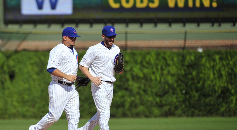 Chicago Cubs&#39 Kyle Schwarber left and Chris Denorfia right jog off the field after the Cubs&#39 9-2 win against the Milwaukee Brewers in a baseball game Thursday Aug. 13 2015 in Chicago. The Cubs won 9-2