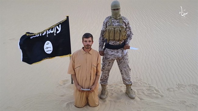 This image made from a militant video posted on a social media site on Wednesday Aug. 5 2015 purports to show a militant standing next to another man who identifies himself as 30-year-old Tomislav Salopek kneeling down as he reads a message at an unkn