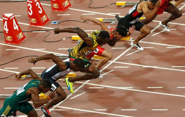 Athletes compete at the start of their heat of the men's 100 metres semi-final during the 15th IAAF World Championships at the National Stadium in Beijing