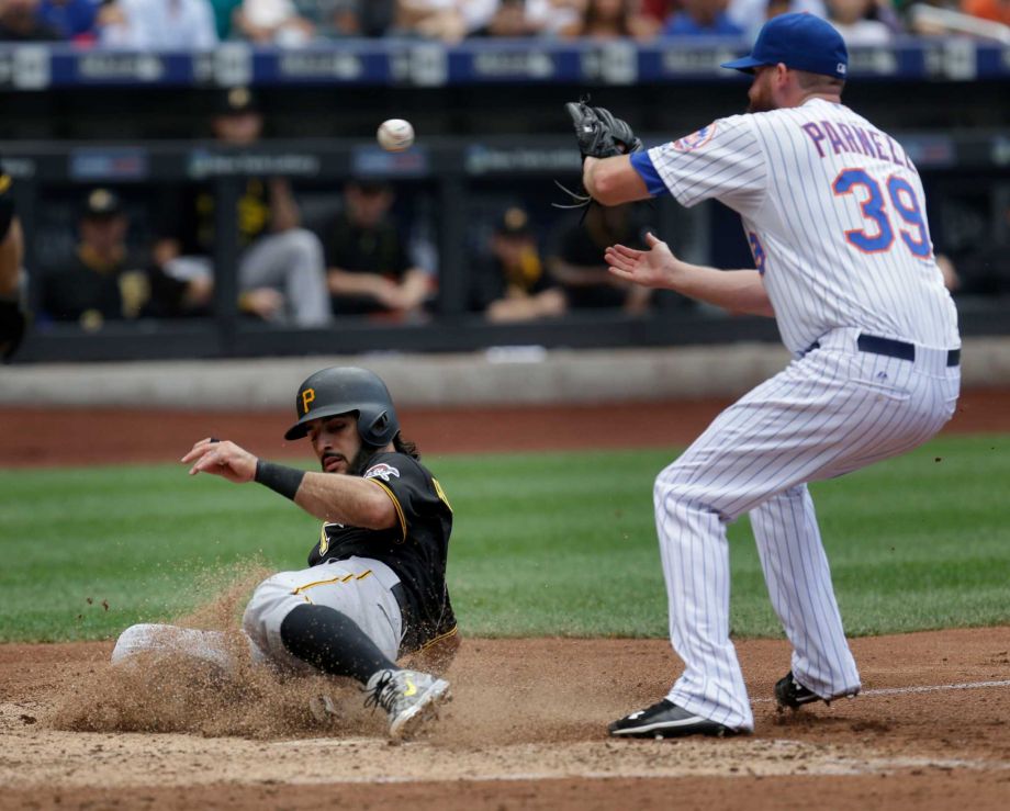 Pittsburgh Pirates Sean Rodriguez left scores past New York Mets relief pitcher Bobby Parnell on a passed ball during the seventh inning of the baseball game at Citi Field Sunday Aug. 16 2015 in New York