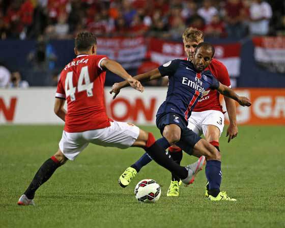 DOUBLE TROUBLE Lucas Moura No.7 of Paris Saint Germain controls the ball between Andreas Pereira No.44 and Luke Shaw No.3 of Manchester United during a match in the 2015 International Champions Cup at Soldier Field on Thursday in Chicago Illinois. AFP P