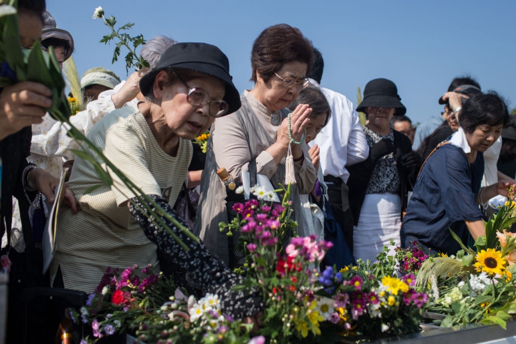 People pray at the Hiroshima Peace Memorial after the 70th anniversary ceremony of the atomic bombing of Hiroshima at the Hiroshima Peace Memorial Park on August 6. Japan marks the 70th anniversary of the first atomic bomb that was dropped by the United S