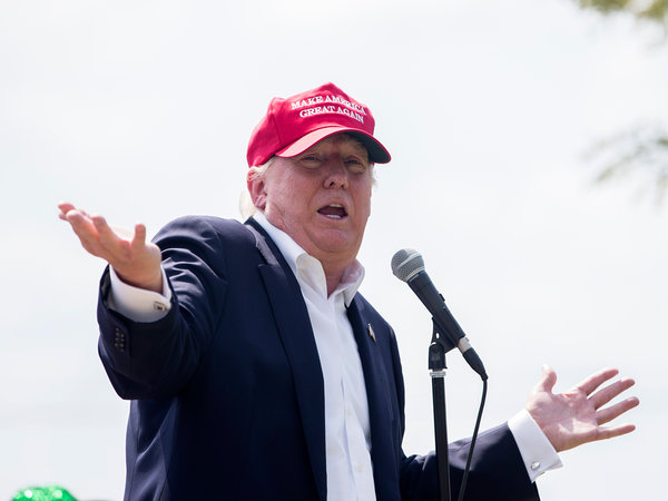 Republican presidential candidate businessman Donald Trump speaks with reporters after arriving at the Iowa State Fair