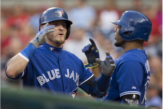 Toronto Blue Jays third baseman Josh Donaldson celebrates with first baseman Edwin Encarnacion after hitting a home run in the first inning in Philadelphia on Tuesday. Donaldson hit another homer later in the game giving him 33 for the season