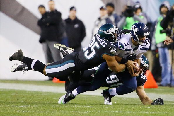 PHILADELPHIA PA- DECEMBER 07 Quarterback Russell Wilson #3 of the Seattle Seahawks is tackled by Mychal Kendricks #95 and Connor Barwin #98 of the Philadelphia Eagles in the first half of the game at Lincoln Financial Field