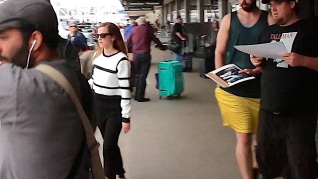 Emma Watson shuffles past fans and