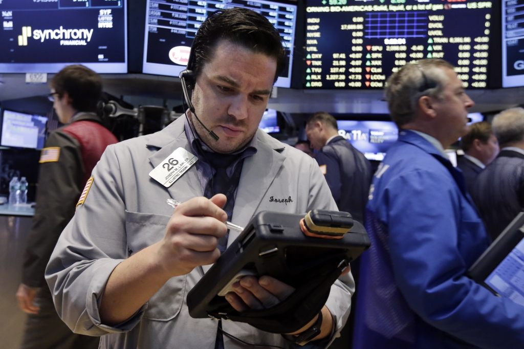 TTrader Joseph Lawler works on the floor of the New York Stock Exchange on Monday Aug. 3 2015. US stocks fell Monday with petroleum-linked equities retreating on a big drop in oil prices as Wall Street girds for a busy week of economic reports. AP PHOT