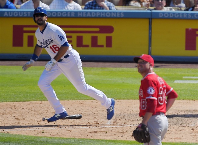 Los Angeles Dodgers Andre Ethier left runs to first as hits a solo home run while Los Angeles Angels relief pitcher Joe Smith watches during the eighth inning of a baseball game Sunday Aug. 2 2015 in Los Angeles