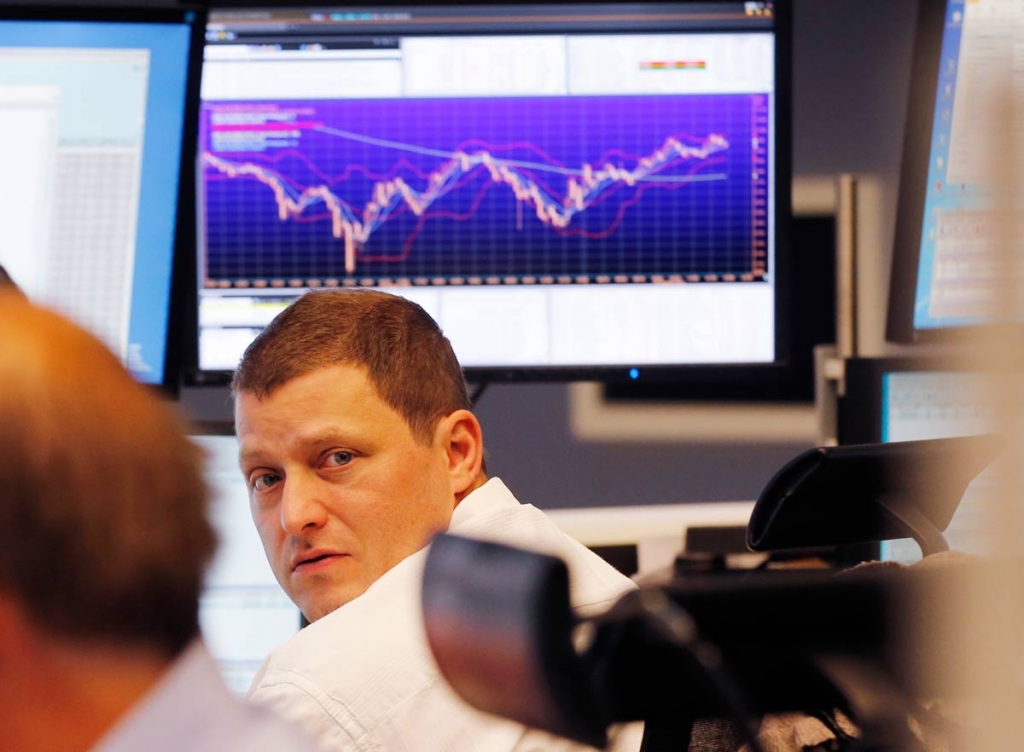 A trader watches his screens when the curve of the German stock index DAX went up close to 10,000 points again at the stock market in Frankfurt German