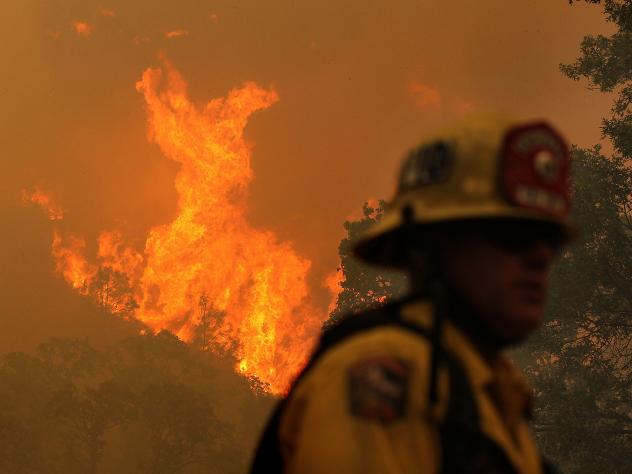 Firefighters with a California Office of Emergency Services strike team take a break from mopping up hot spots on the Rocky Fire. Career firefighters working the blaze say they've never before seen a wildfire burn