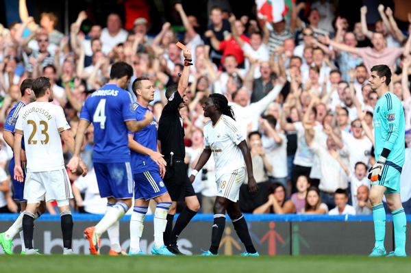 Chelsea goalkeeper Thibaut Courtois is shown a red card after bringing down Swansea City's Bafetimbi Gomis during the Barclays Premier League match at Stamford Bridge London