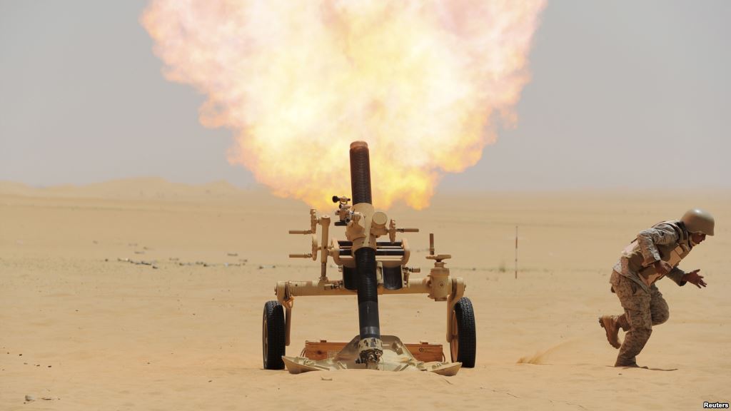 FILE- A Saudi soldier fires a mortar towards Houthi rebel positions at the Saudi border with Yemen