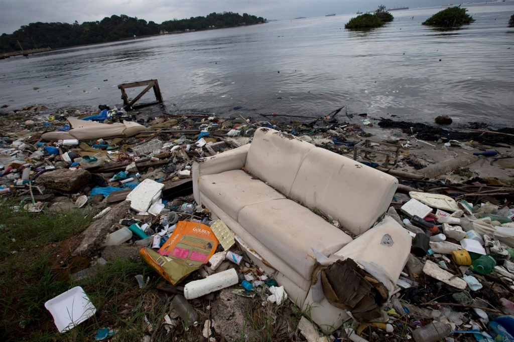 Image A discarded sofa litters the shore of Guanabara Bay in Rio