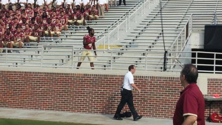 Florida State takes one team photo with player facing battery charge, one without