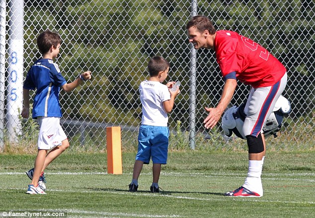 Family break Brady's sons John and Benjamin run up to their dad following his practice in Foxboro Massachusetts on Monday