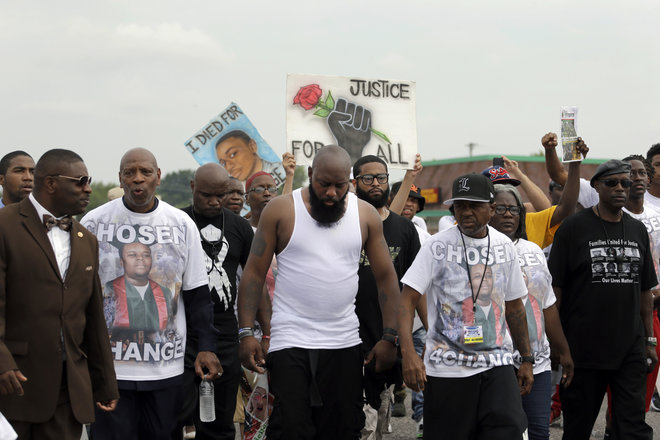 Michael Brown Sr. center takes part in a parade in honor of his son Michael Brown Saturday Aug. 8 2015 in Ferguson Mo. Sunday will mark one year since Michael Brown was shot and killed by Ferguson police officer Darren Wilson. (AP