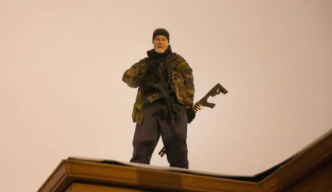 Heavily armed civilians with a group known as the Oath Keepers arrive in Ferguson Mo. early Tuesday Aug. 11 2015. The far-right anti-government activists largely consists of past and present members of the military first responders and police office