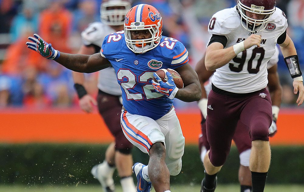 Adam Lane #22 of the Florida Gators carries past defender Robby Irgang #90 of the Eastern Kentucky Colonels of the game at Ben Hill Griffin Stadium