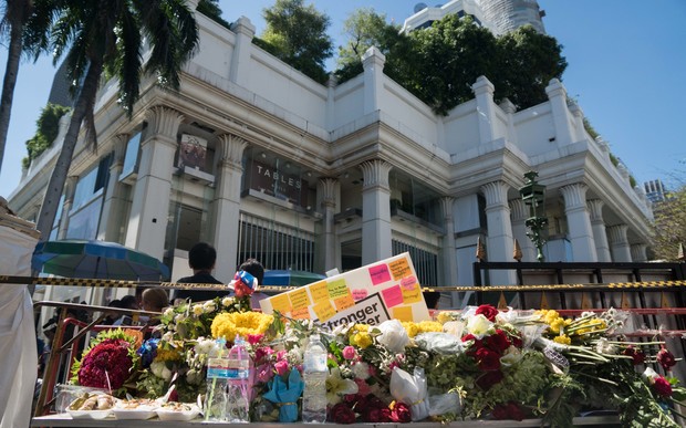 Flowers are laid at the entrance to the reopened Erawan Shrine in Bangkok