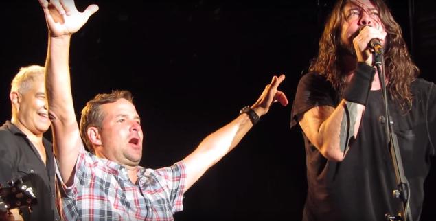 Dave Grohl brings up a crying fan to join him on stage for a duet during the Foo Fighters’ concert Sunday night in Colorado