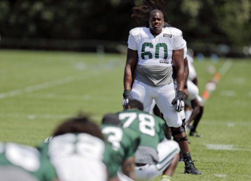 New York Jets tackle D'Brickashaw Ferguson stretches with teammates during practice at NFL football training camp Wednesday Aug. 5 2015 in Florham Park N.J