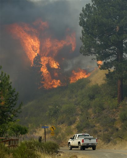 Forest Service truck drives near a hillside