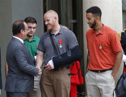 French President Francois Hollande bids farewell to U.S. Airman Spencer Stone as U.S. National Guardsman Alek Skarlatos of Roseburg Ore. second from left and Anthony Sadler a senior at Sacramento State University in California right look on at the E