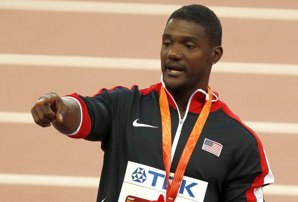 The Latest Gatlin defends mom from podium stand at worlds