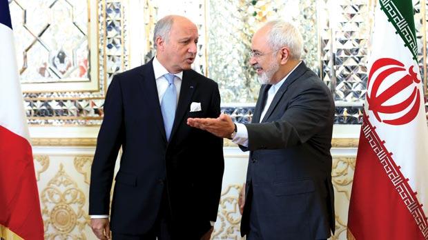 French foreign minister Laurent Fabius and his Iranian counterpart Mohammad Javad Zarif arrive for a meeting in Tehran