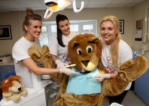 From left Brydie McAnaney Sydney Pyke and Anthea Griffiths from Oliver's Dentist Studio with mascot Ollie the Lion