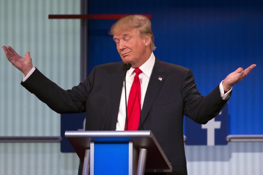 Real estate tycoon Donald Trump flashes the thumbs-up as he arrives on stage for the start of the prime time Republican presidential debate