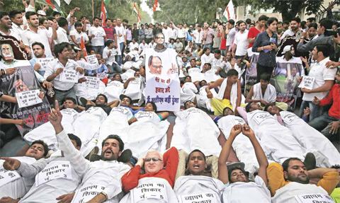 India’s opposition Congress party’s youth wing activists shout slogans demanding the resignation of three key ruling party leaders accused of abusing their authority and financial irregularities during a protest near the Indian Parliament in New Delhi