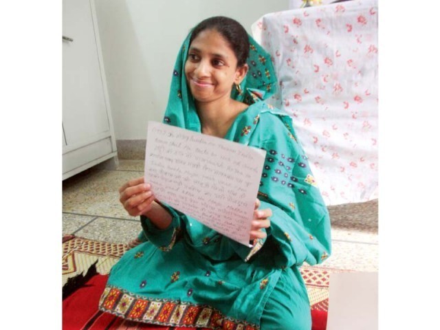 Geeta smiles as she shows one of her writings in Hindi