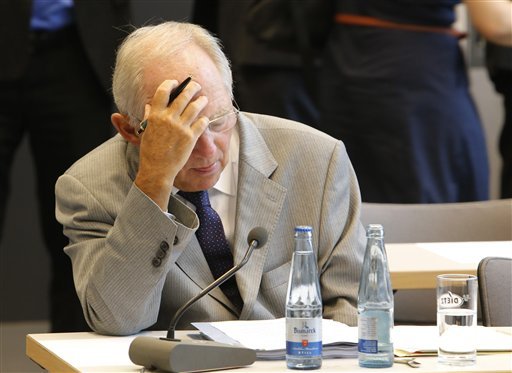 German Finance Minister Wolfgang Schaeuble waits for the beginning of a meeting of the Christian Democratic Party's parliamentary faction on the eve of Wednesday's vote on another bailout package for Greece in the German Bundestag in Berlin Tuesday Aug