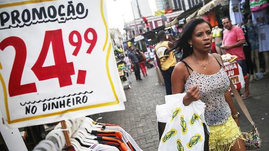 A woman walks in a shopping district in Rio de Janeiro