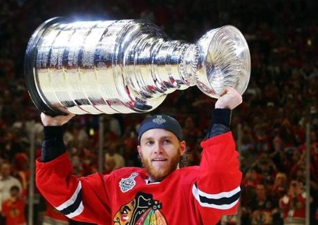 CHICAGO IL- JUNE 15 Patrick Kane #88 of the Chicago Blackhawks celebrates by hoisting the Stanley Cup after defeating the Tampa Bay Lightning by a score of 2-0 in Game Six to win the 2015 NHL Stanley Cup Final at the United Center