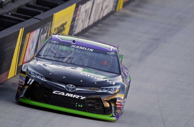 Driver Denny Hamlin comes down the back straight during qualifying for a NASCAR Sprint Cup Series auto race