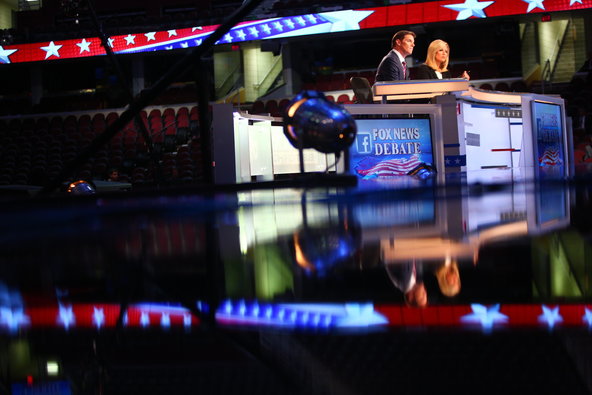 Republican presidential candidates from left Jim Gilmore Lindsey Graham Bobby Jindal Rick Perry Rick Santorum Carly Fiorina and George Pataki take the stage for a pre-debate forum at the Quicken Loans Arena in Cleveland. The seven candidates did