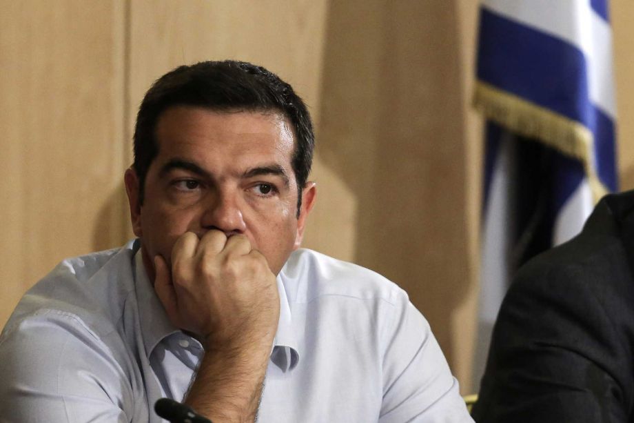 Greek Prime Minister Alexis Tsipras listens during his visit at the transport ministry in Athens Wednesday Aug. 12 2015. Details of Greece’s latest bailout package were being pored over across Europe on Wednesday as Prime Minister Alexis Tsipras insi