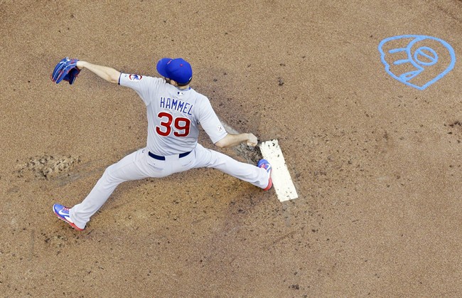 Chicago Cubs starting pitcher Jason Hammel throws during the first inning of a baseball game against the Milwaukee Brewers Friday