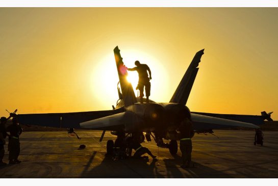 Royal Canadian Air Force ground crew perform post flight checks on a CF-18 fighter jet in Kuwait after a sortie over Iraq in November 2014