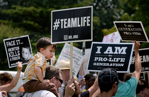 Anti-abortion activists hold a rally July 28 opposing federal funding for Planned Parenthood in front of the U.S. Capitol