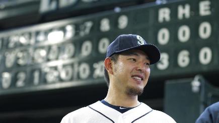 Hisashi Iwakuma poses in front of the scoreboard after throwing a rare no-hitter