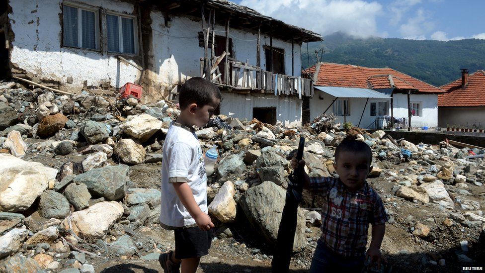 Boys stand on a street in the flooded village of Sipkovica near the town of Tetovo Macedonia 4 August 2015