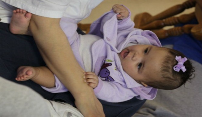 Infant Girl Smiles at Mom